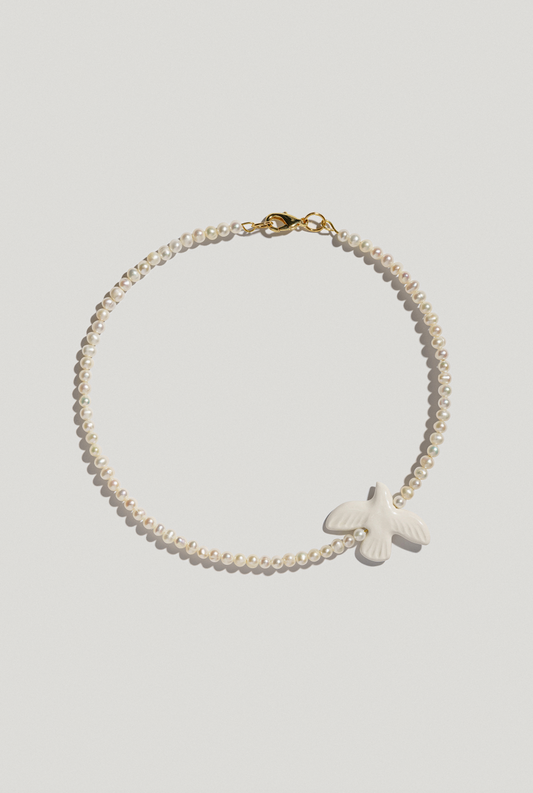 Necklace with small river pearls and a bird