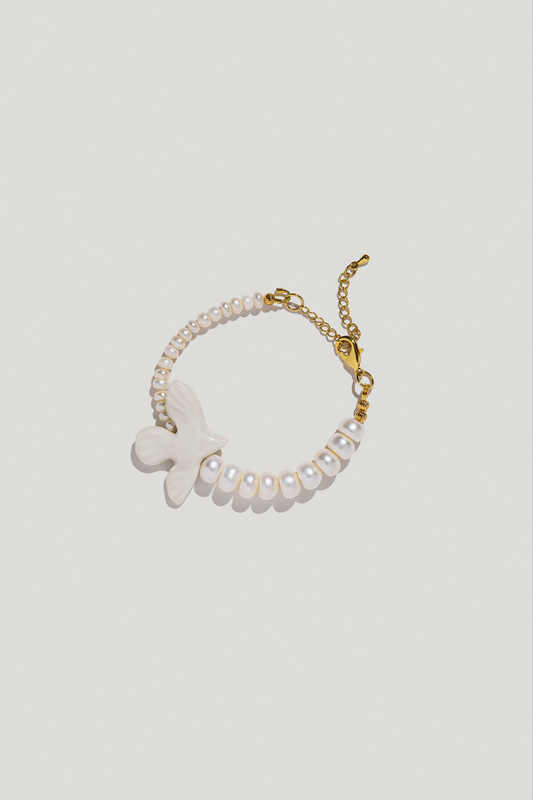 Wristband with two types of pearls and a porcelain bird