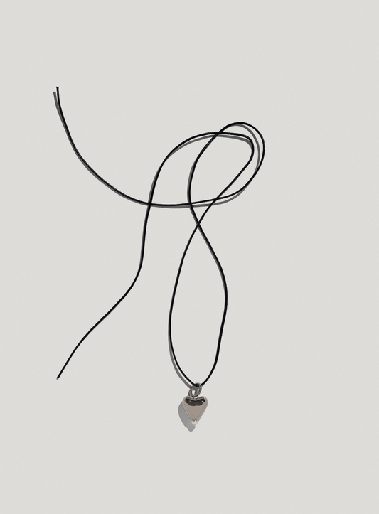 [S K A R B] small platinum plated heart pendant on a cord