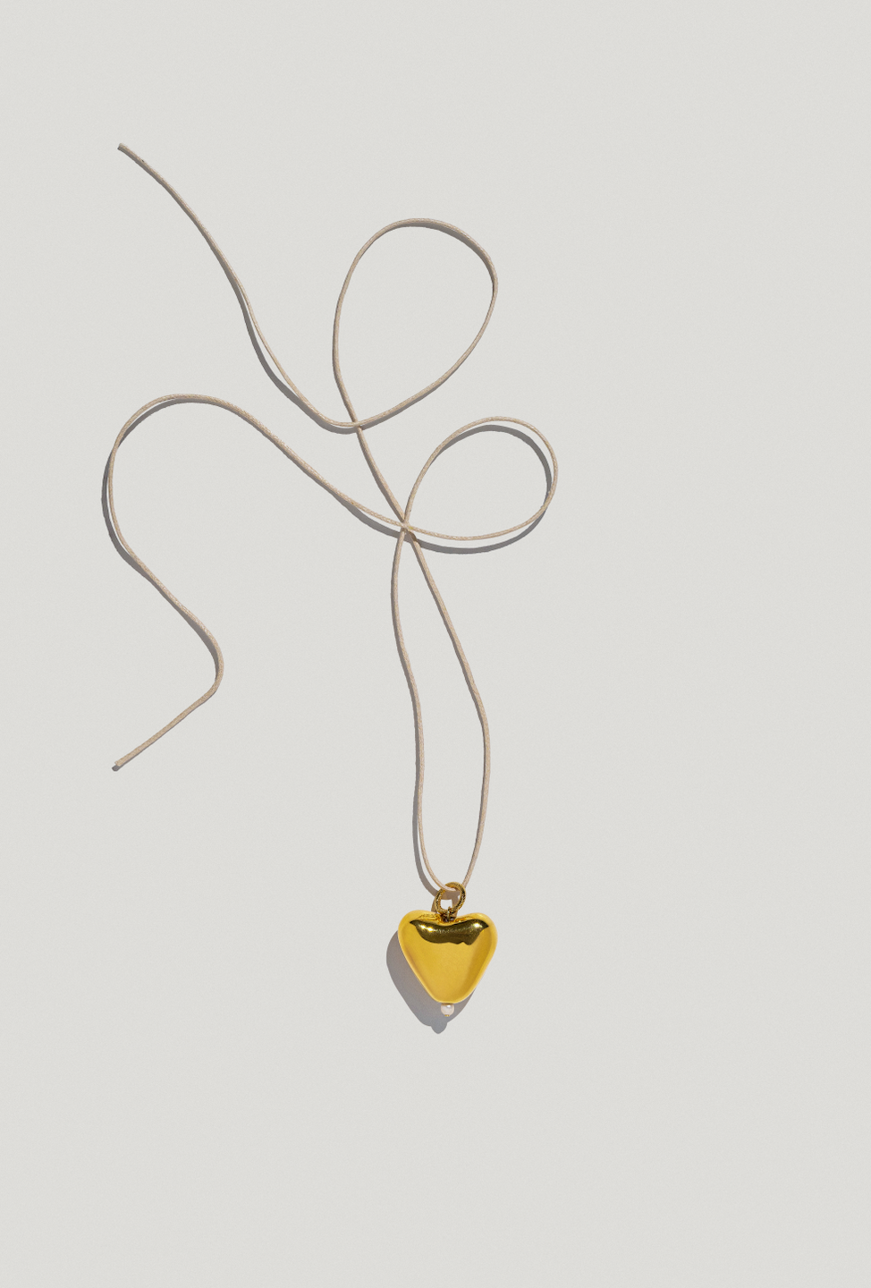 [S K A R B] big gold plated heart pendant on a cord