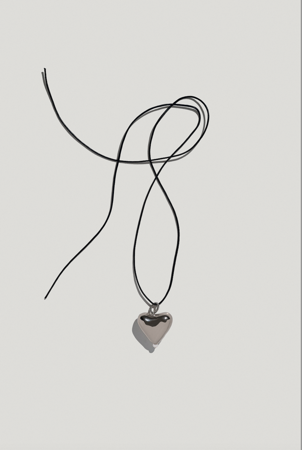 [S K A R B] big platinum plated heart pendant on a cord