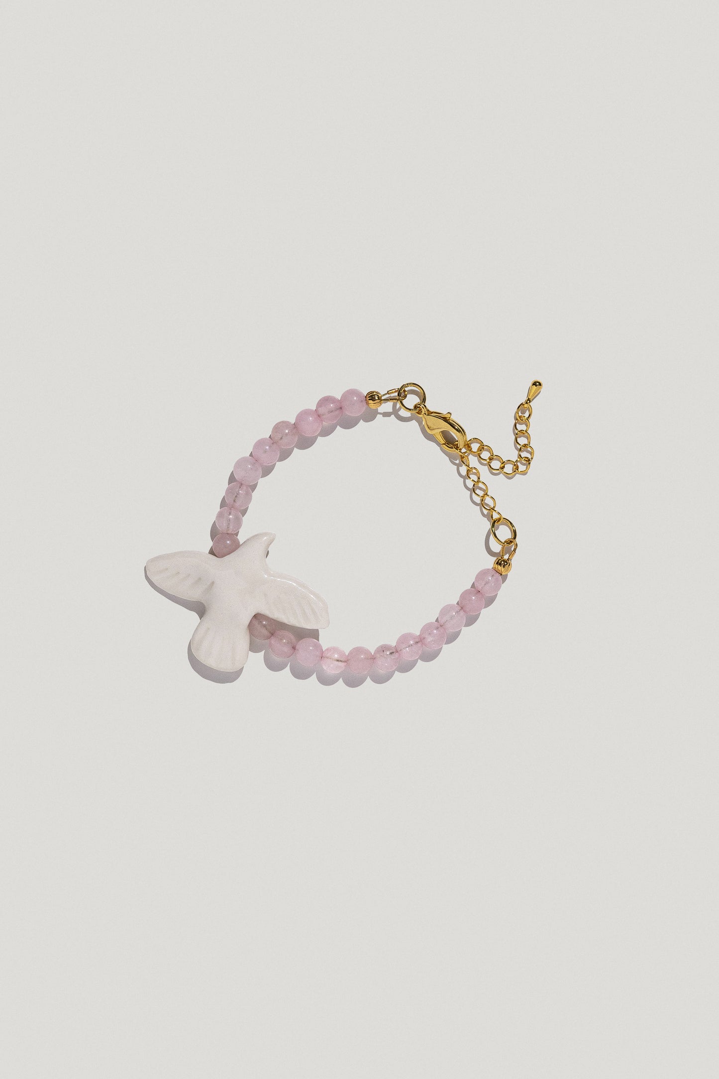 [M Y R N I] wristband with bubble-gum quartz and a porcelain bird