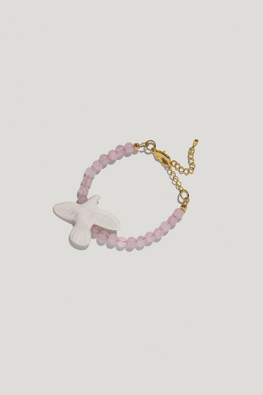 [M Y R N I] wristband with bubble-gum quartz and a porcelain bird