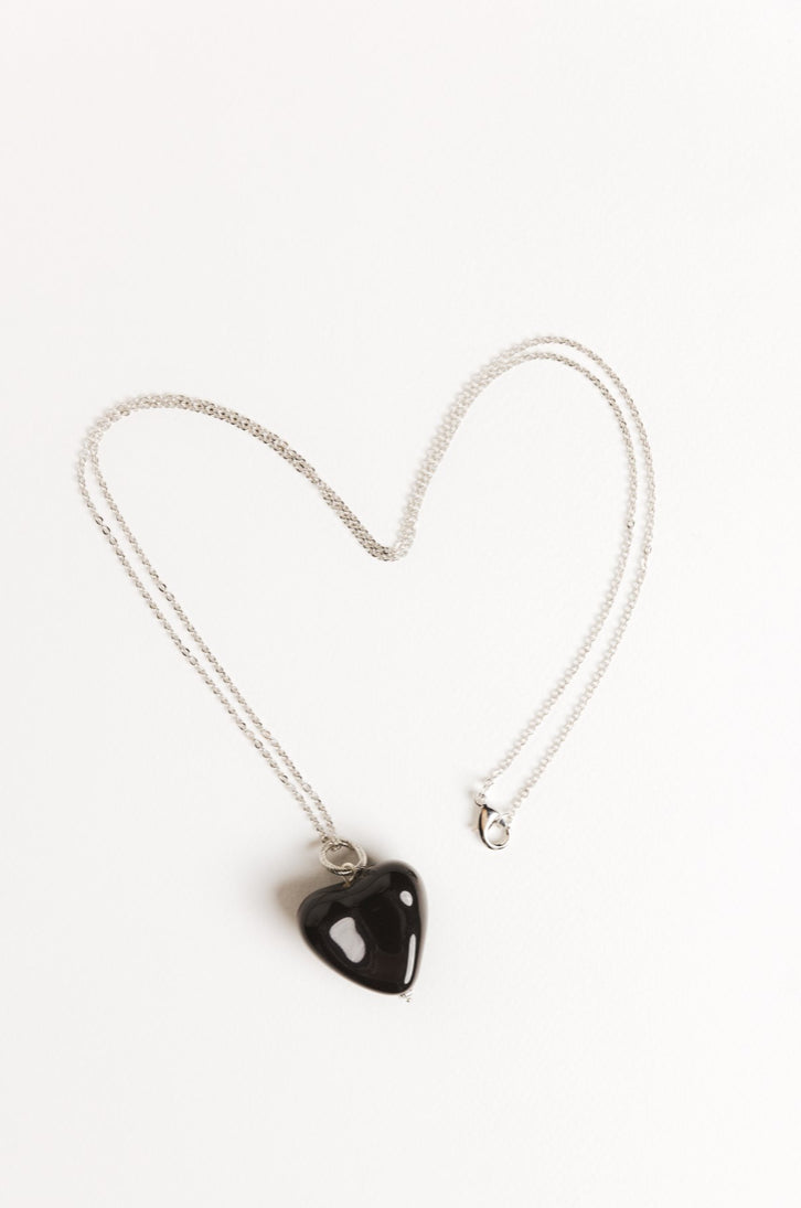 AURA pendant with a black heart on a chain