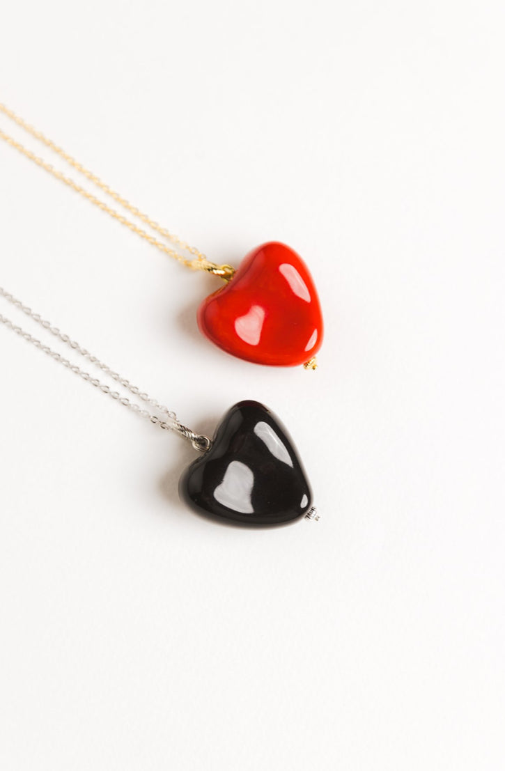 AURA pendant with a black heart on a chain