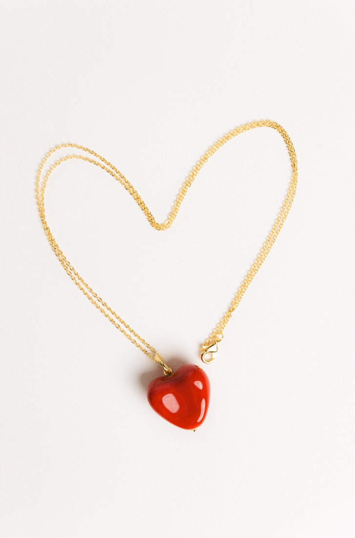 AURA pendant with a red heart on a chain