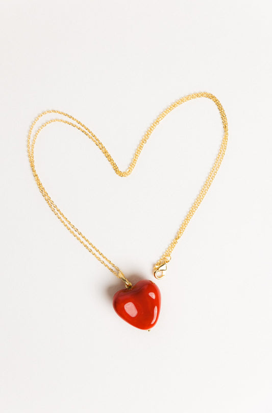 AURA pendant with a red heart on a chain