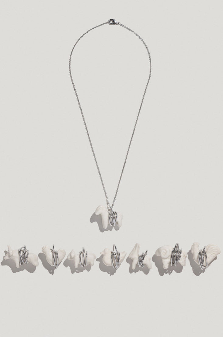 LIULI pendant in a metal frame on a chain duck