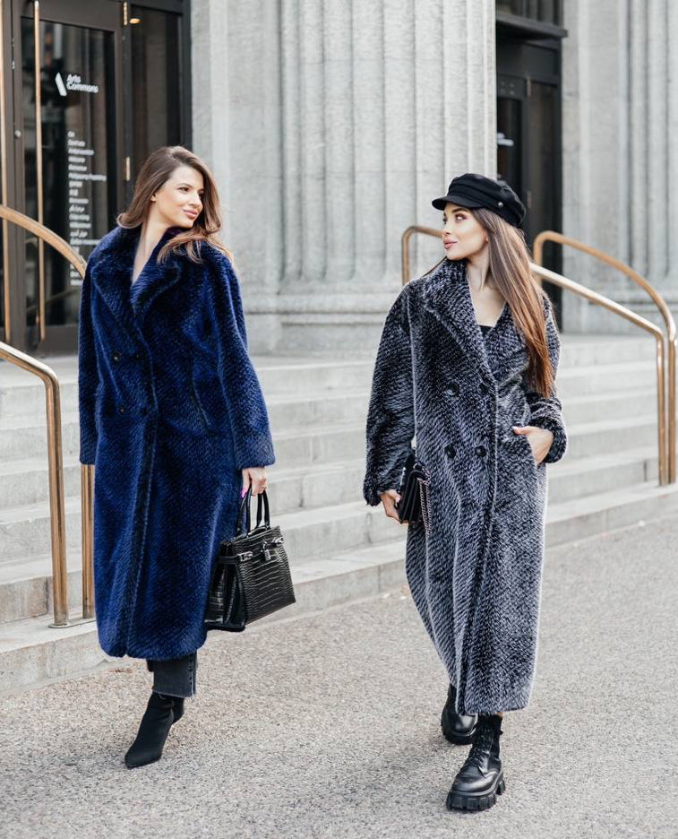 This coat impresses with its length and embodies luxury and elegance