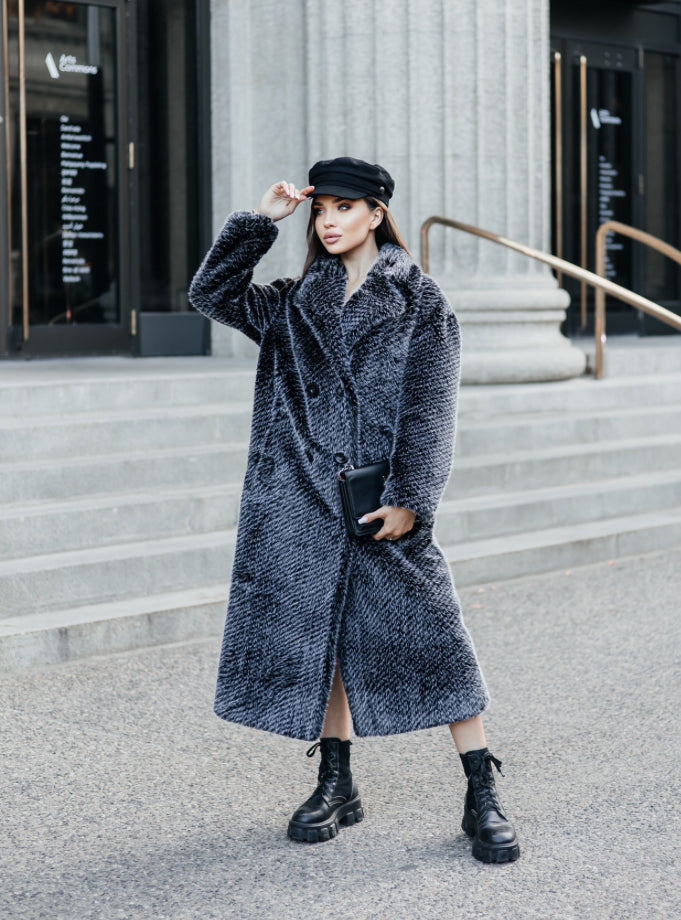 This coat impresses with its length and embodies luxury and elegance