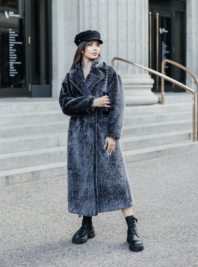 This coat impresses with its length and embodies luxury and elegance