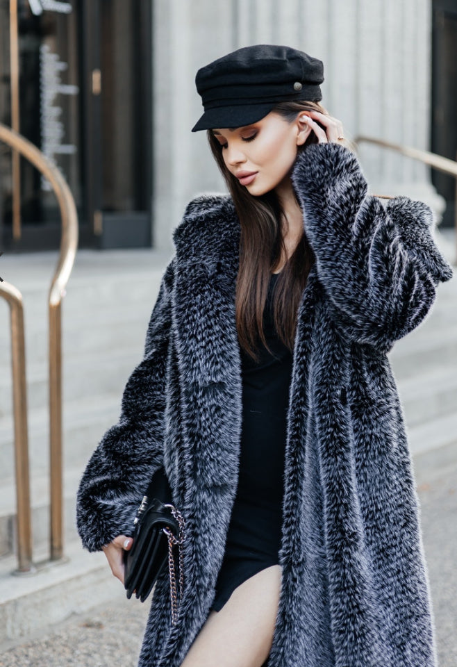 This coat impresses with its length and embodies luxury and elegance