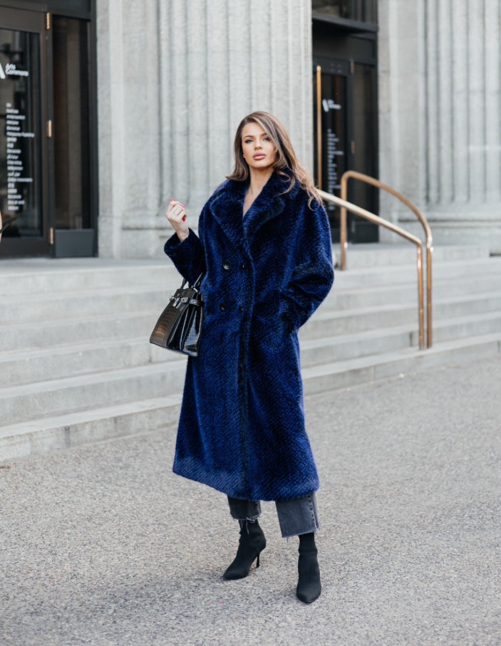This coat impresses with its length and embodies luxury and elegance